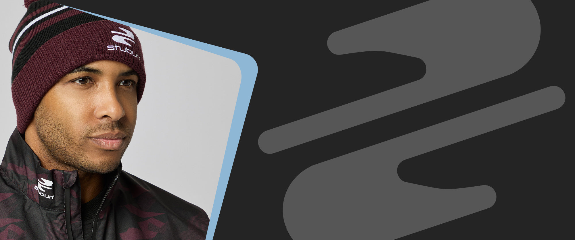 Man wearing a maroon beanie and jacket with a brand logo, against a dark background with abstract shapes.