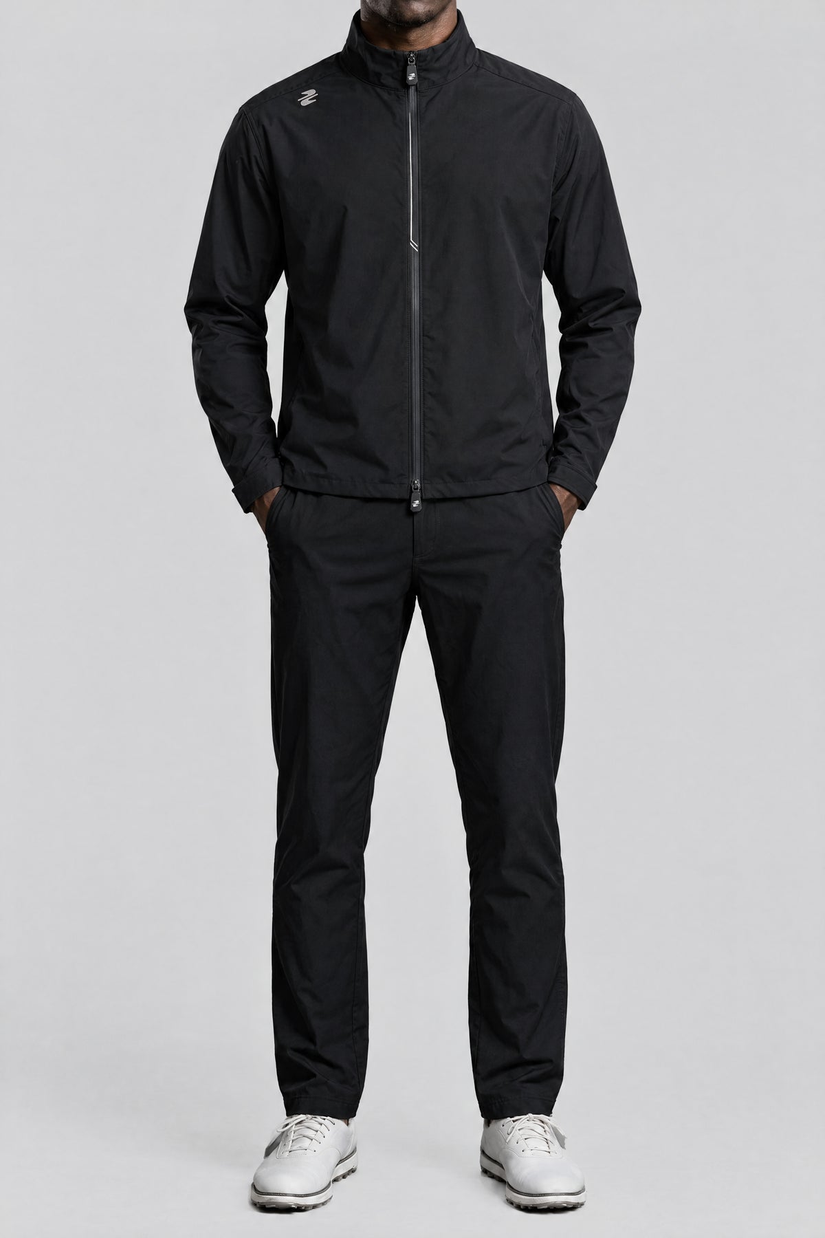 The waterproof golf suit in Black, front