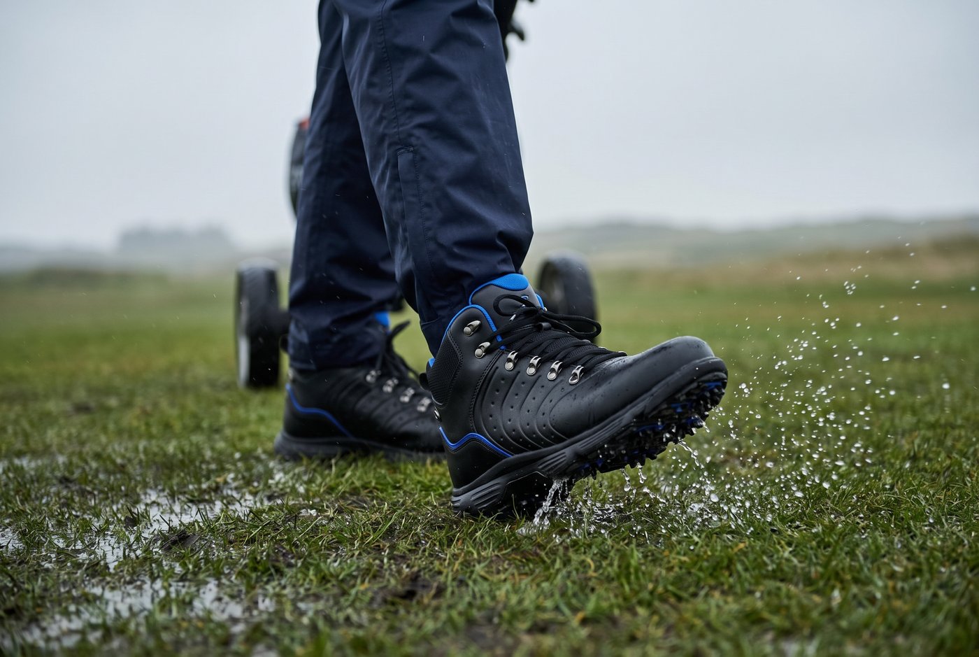 Walking a rain-soaked winter fairway in the Evolve Sport II, water shedding off the spiked sole
