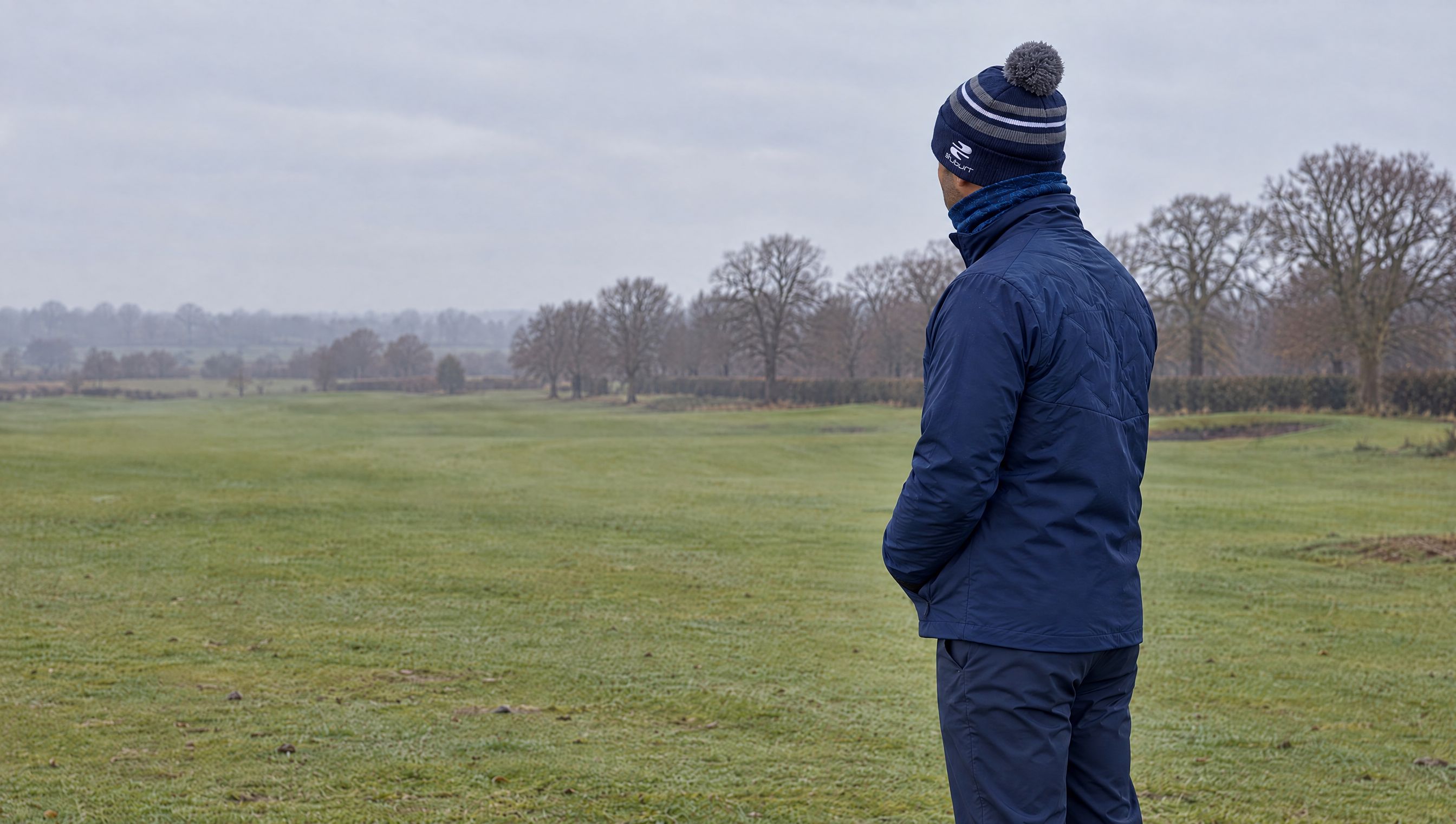 A golfer in the Stuburt winter kit on a parkland fairway